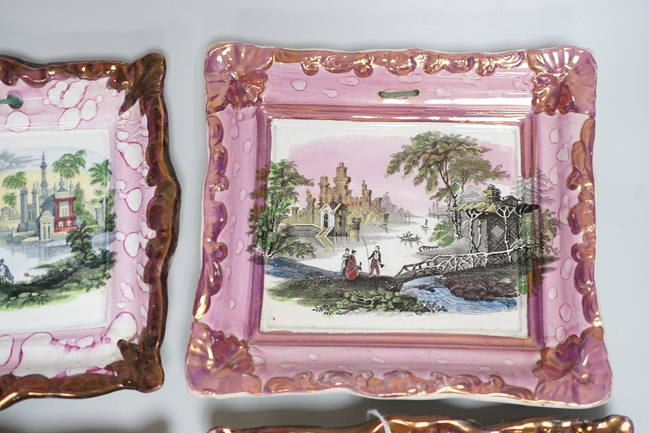 A set of four Dixon and Co. Sunderland pink lustre rectangular plaques, with copper lustre borders printed and hand coloured, impressed marks, 22cm wide